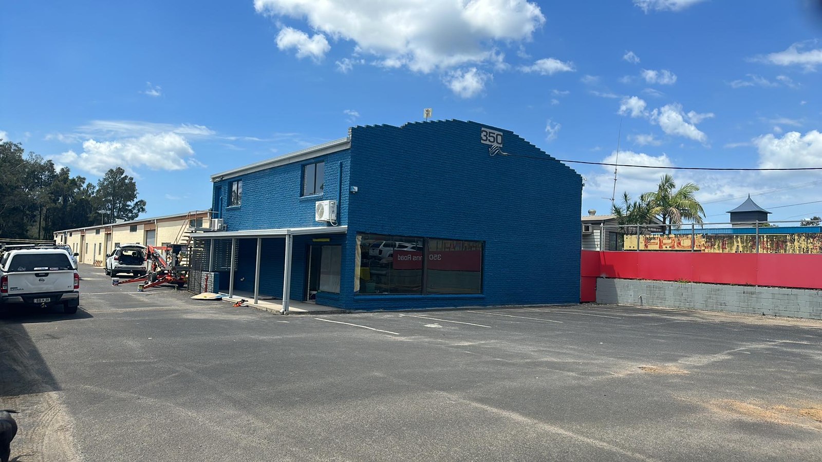 The same retail premises after a full exterior repaint in deep blue