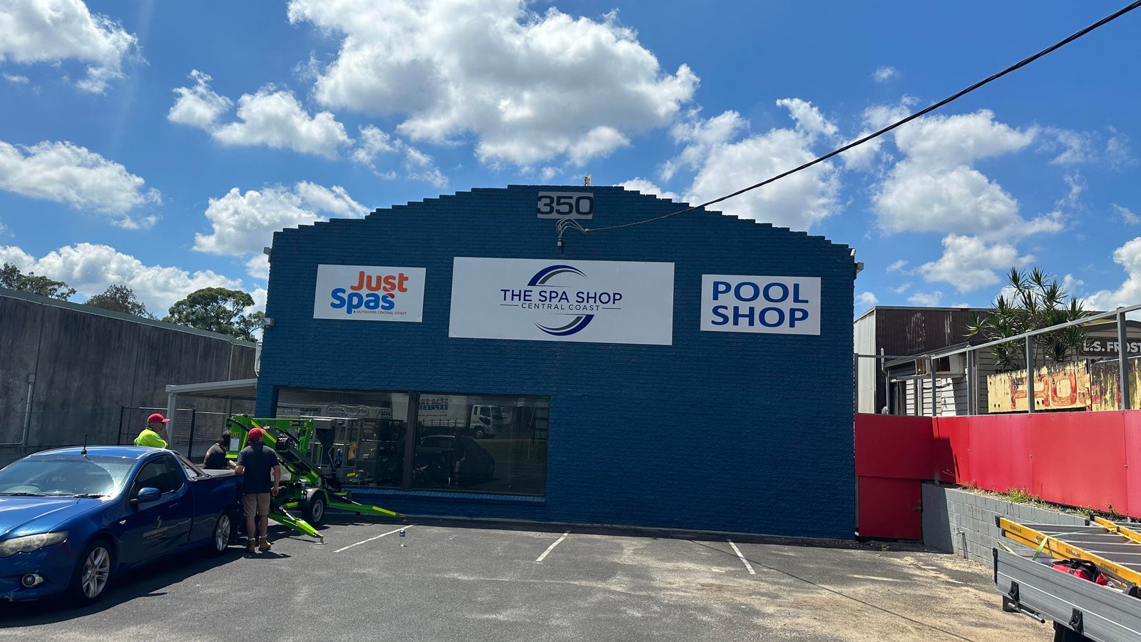 Repainted retail frontage in deep blue with signage reinstalled