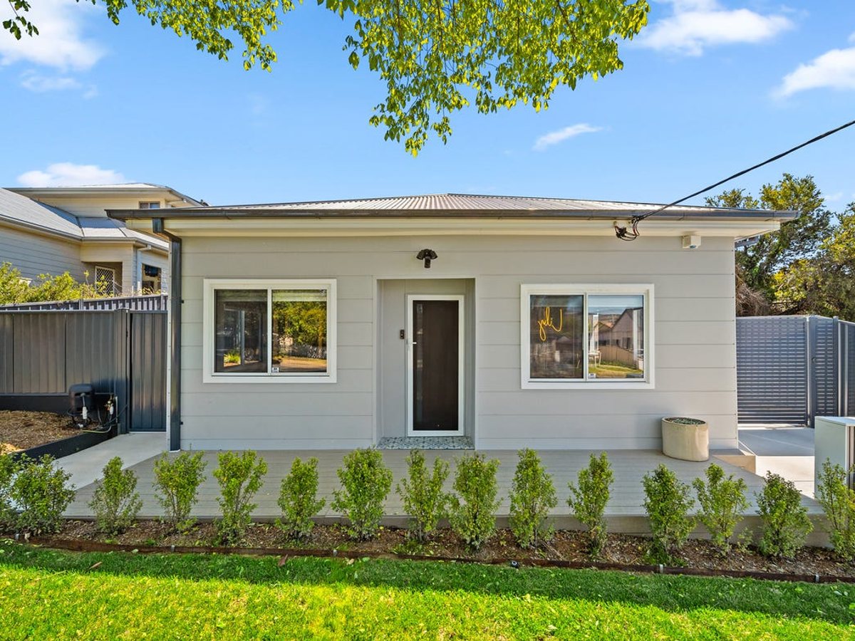 Home exterior after a full repaint, modern grey weatherboard finish, Canberra