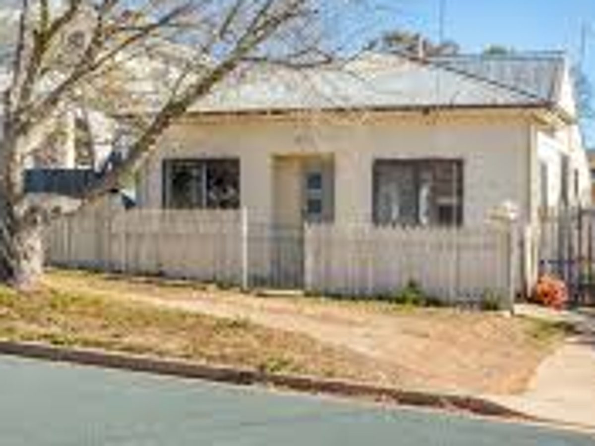 Tired weatherboard home before its exterior repaint, Canberra