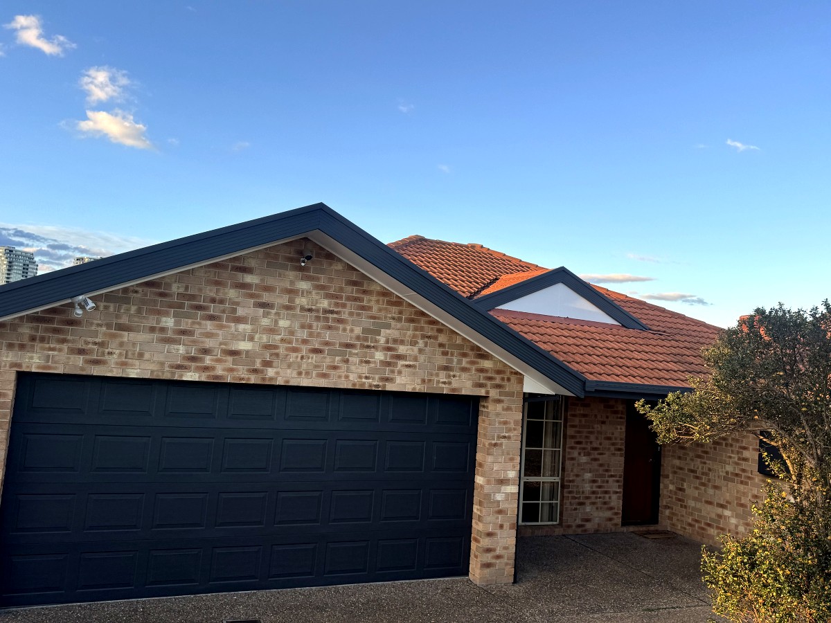 Gungahlin home front elevation after repainting fascia, barge boards and garage door in Colorbond Monument