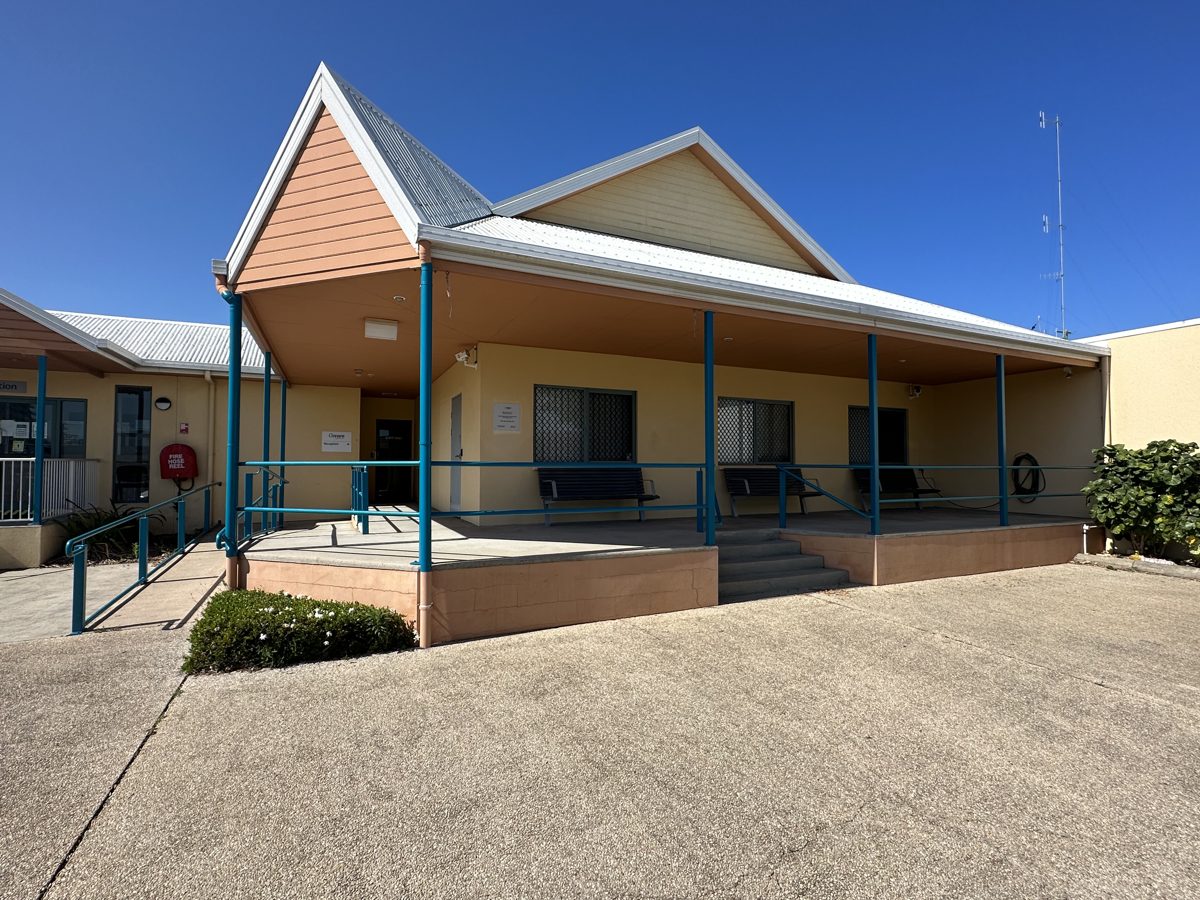 Commercial facility entry with freshly repainted blue handrails