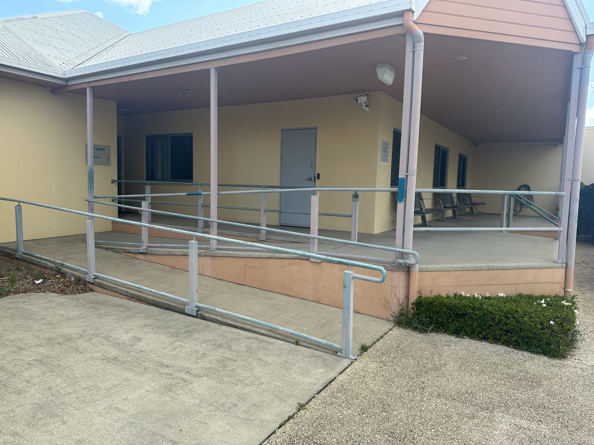 Commercial facility entry ramp and handrails before repainting