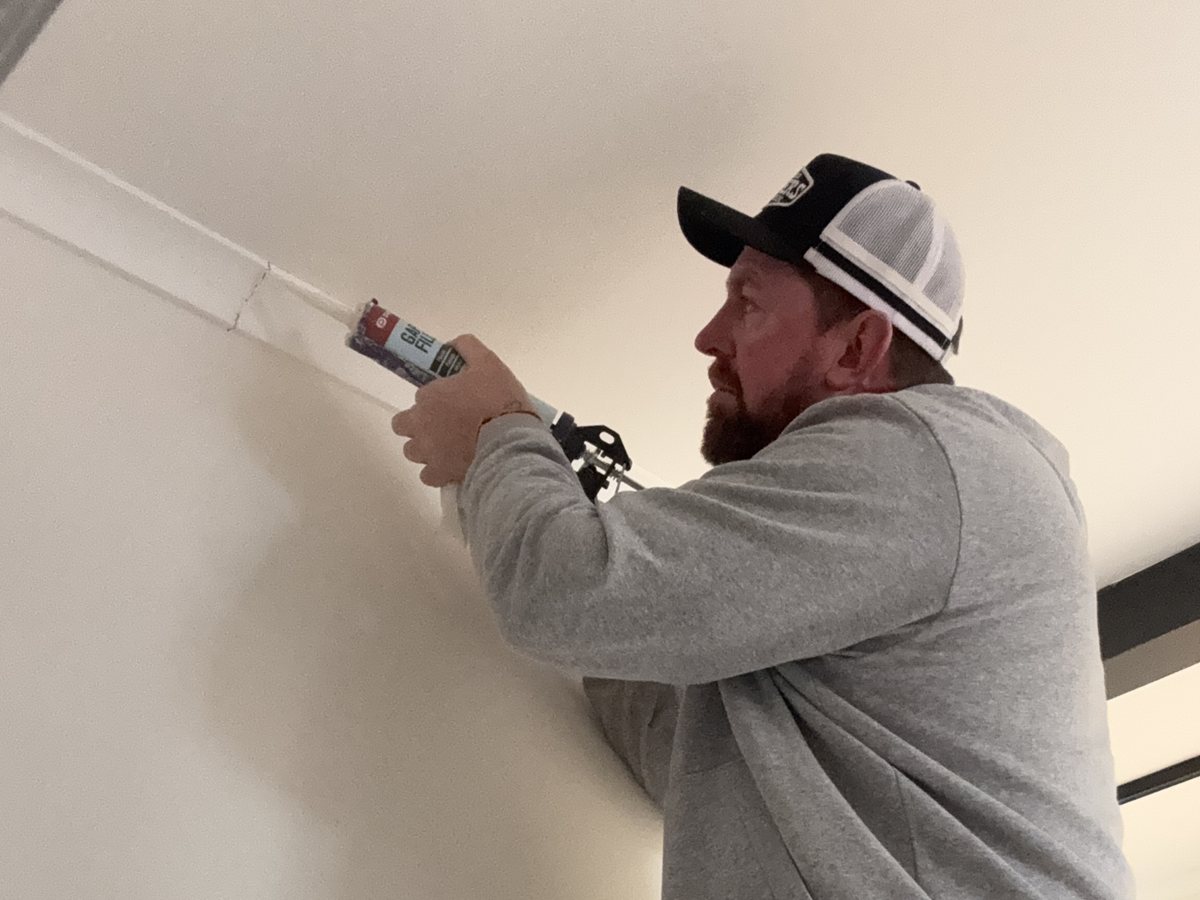 Jason Huntly gap filling cornice during property maintenance in Canberra