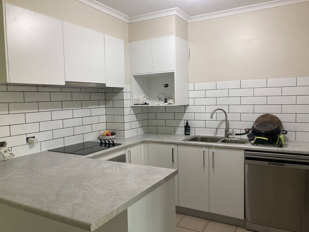 Kitchen after a full repaint and refresh, bright white finish, Canberra