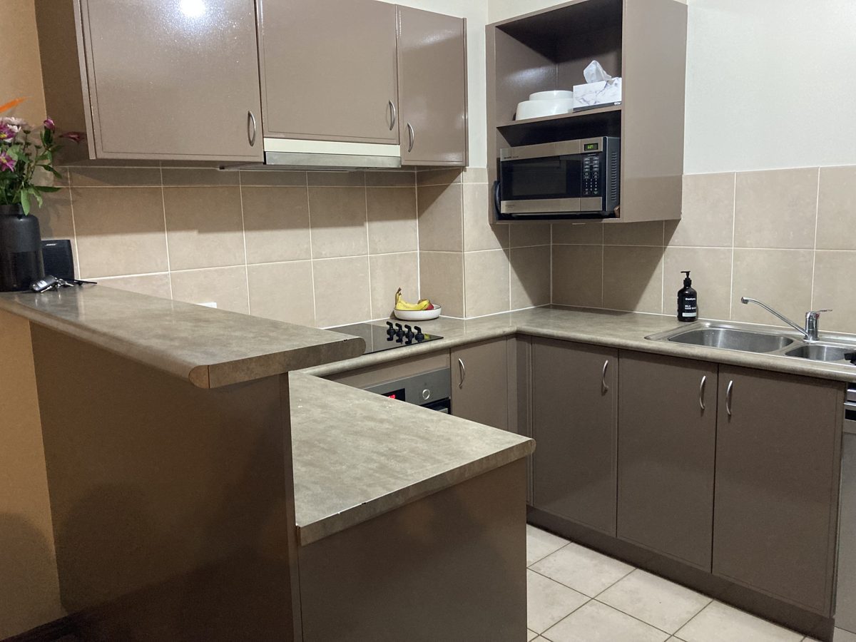 Dated brown kitchen before repaint, Canberra