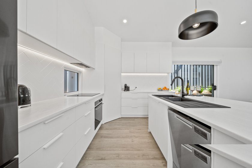 New white kitchen with herringbone splashback