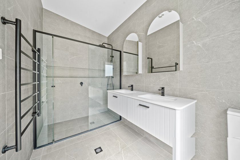 New bathroom with double vanity and walk-in shower